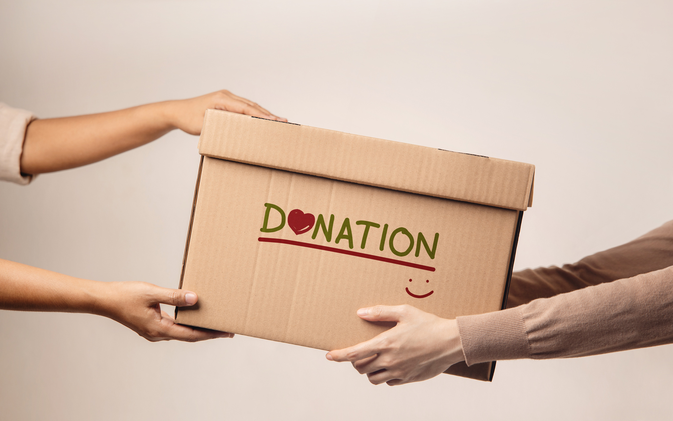 Donation Concept. The Volunteer Giving a Donate Box